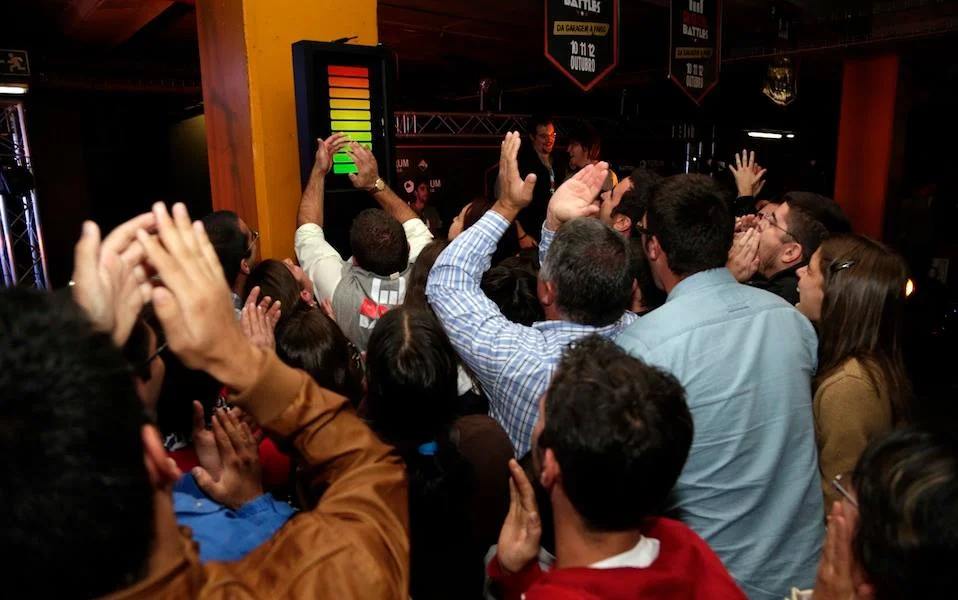 Crowd applauding, arms in the air, during the event.