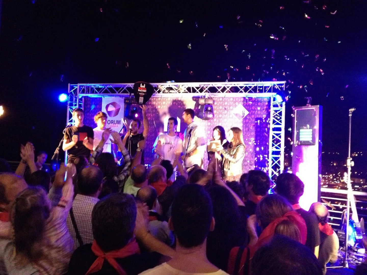 Crowd applauding, arms in the air, during the event.