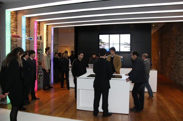 Visitors and staff at a modern Porto e Norte tourism desk.
