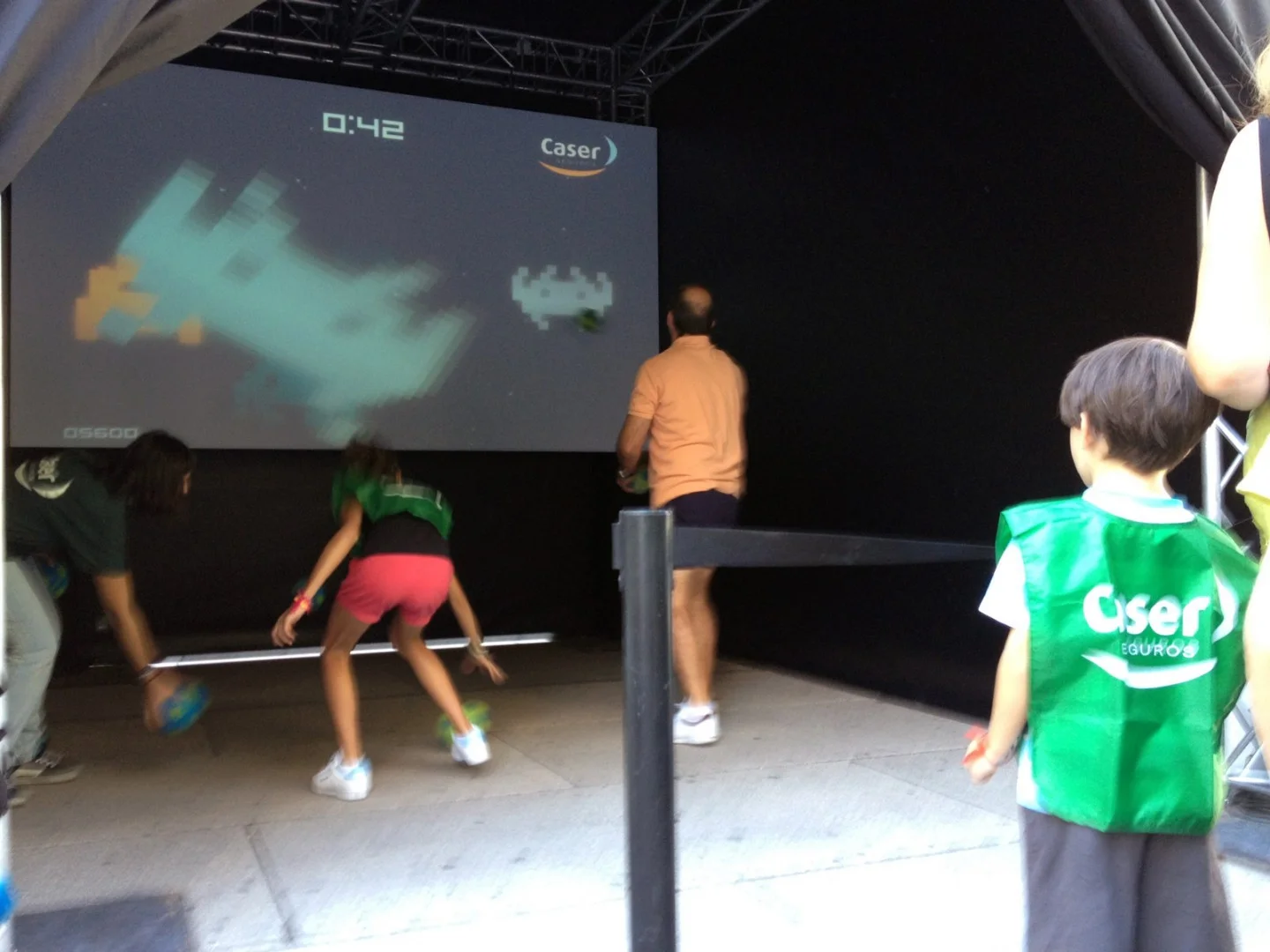 Players throwing balls at the screen.