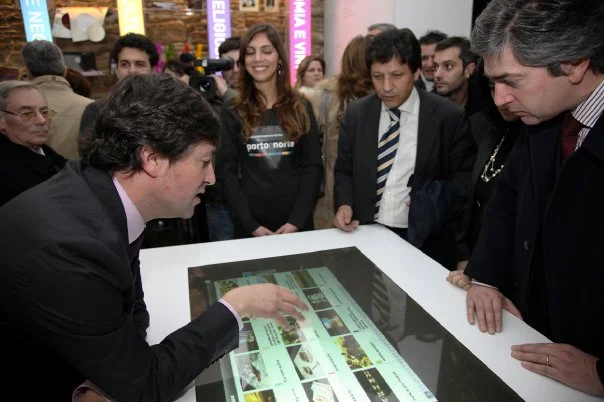 Interactive table presented to a group of visitors.